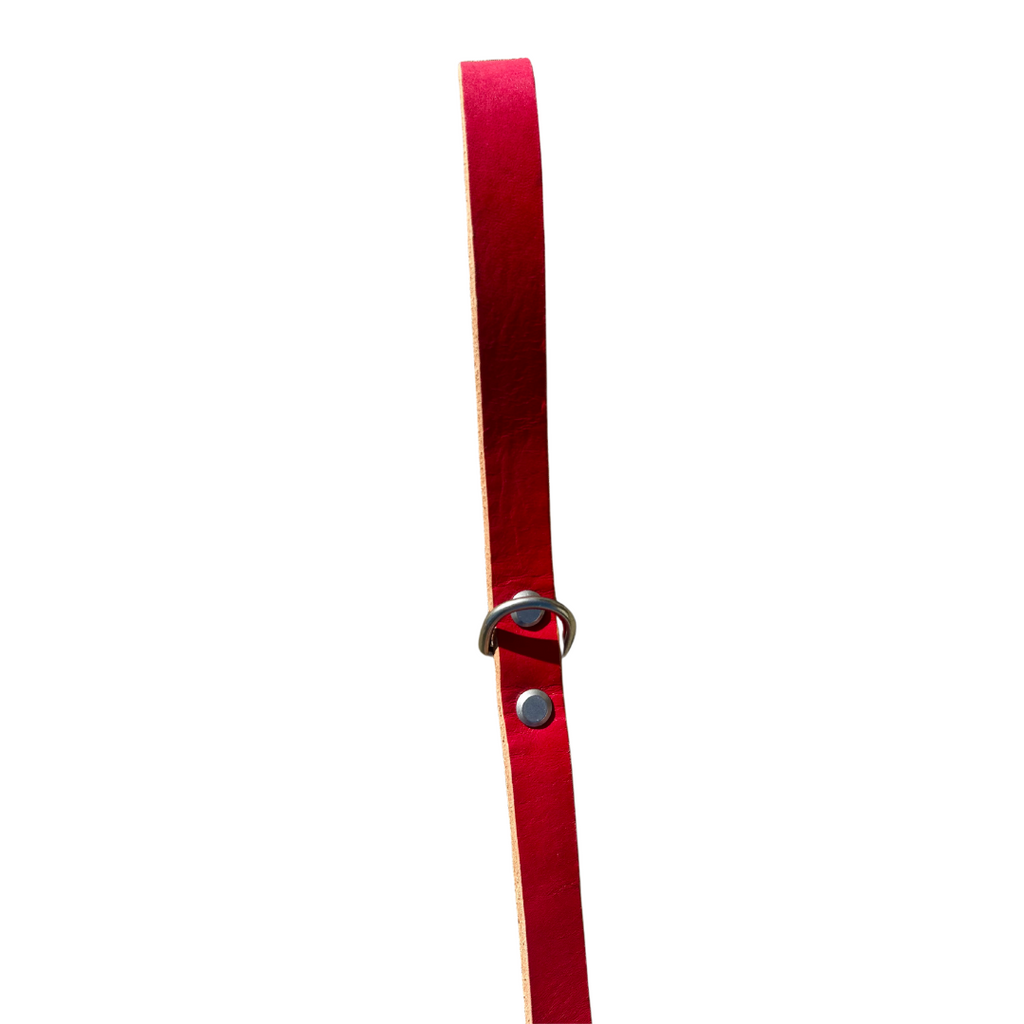 Red leather belt with a silver buckle on a white background