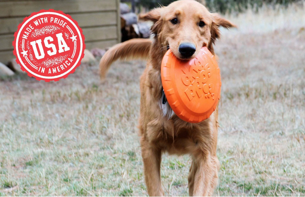 Dog running with an orange frisbee in its mouth, with a 'Made with Pride in America' USA stamp in the corner.