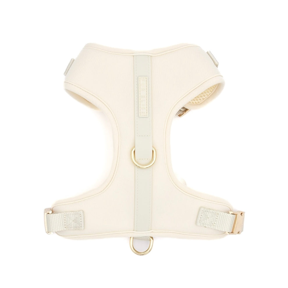 Cream-colored dog harness on a white background
