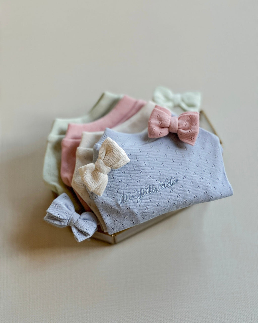 Set of baby headbands with bows on a neutral background