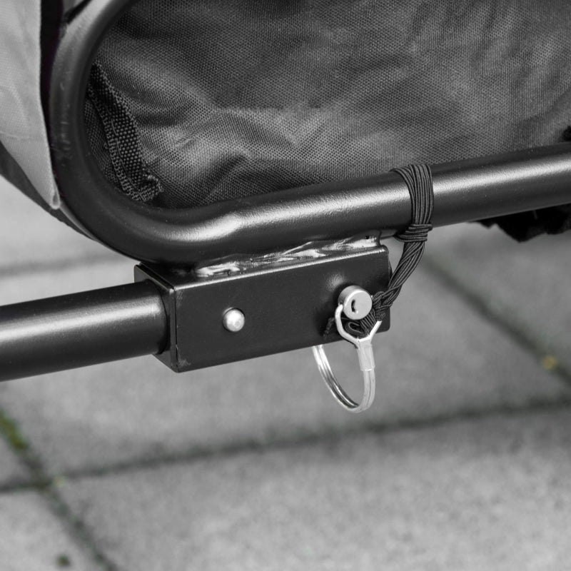 Close-up of a metal bracket attached to a mesh bag on a gray surface
