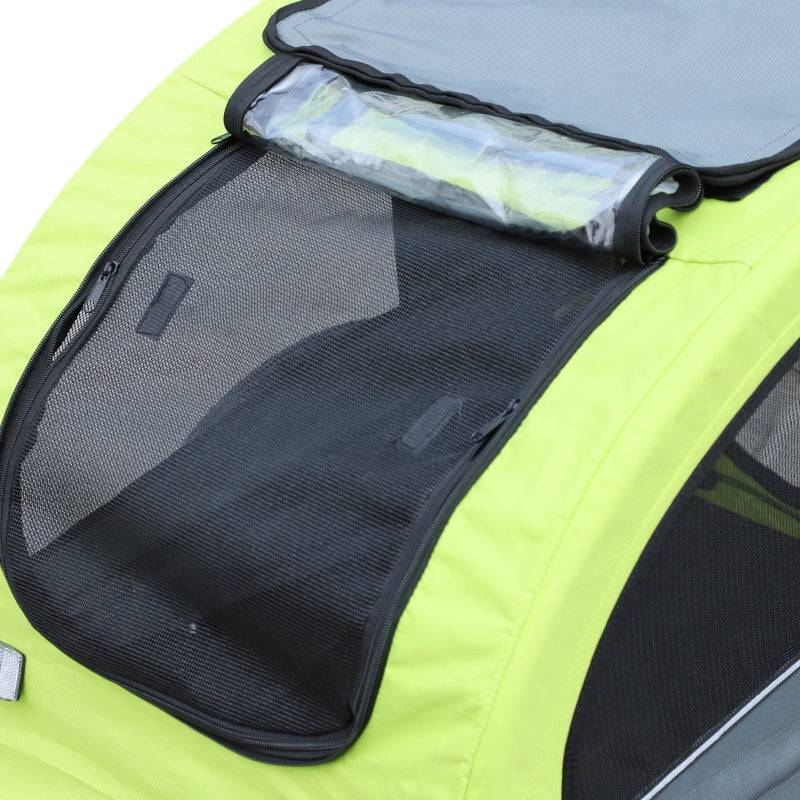 Green pet carrier with mesh side and rolled-up mat inside